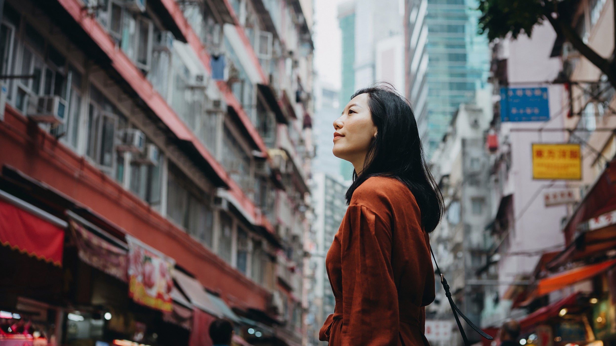 Woman looking at city buildings