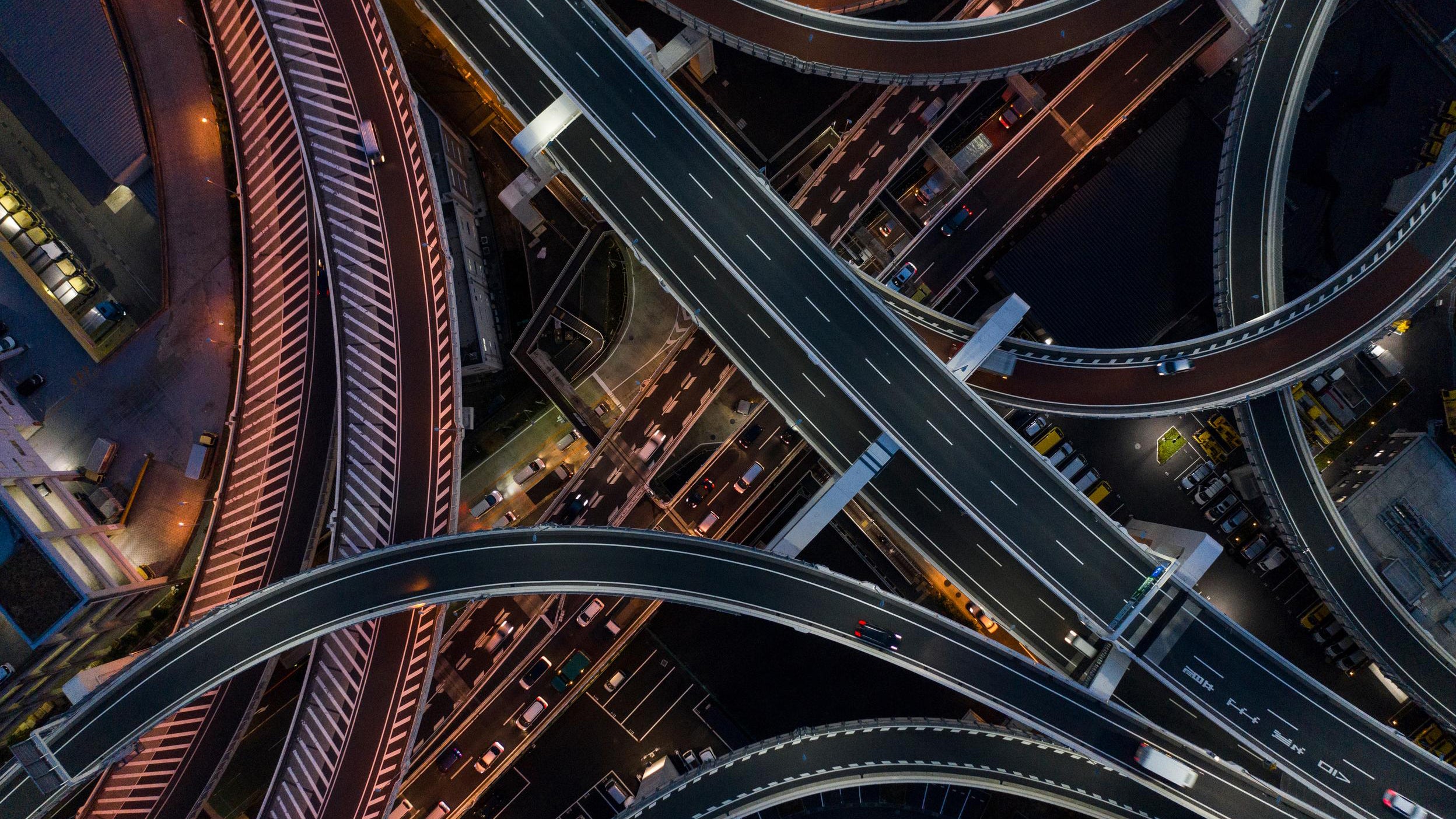 Aerial view of a busy highway interchange at night.