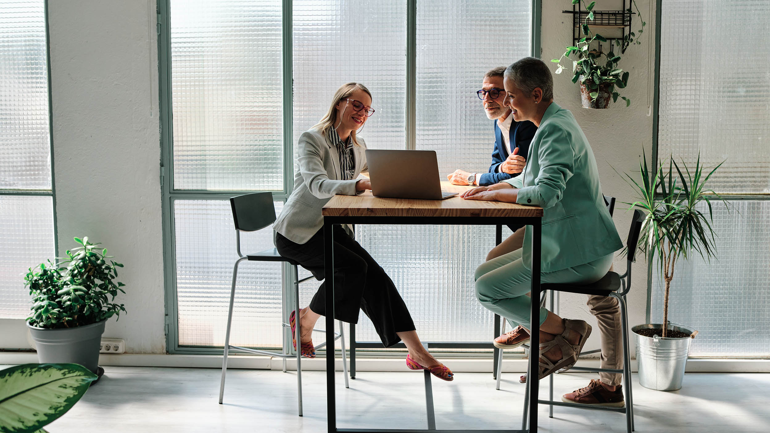 A financial advisor meeting with clients