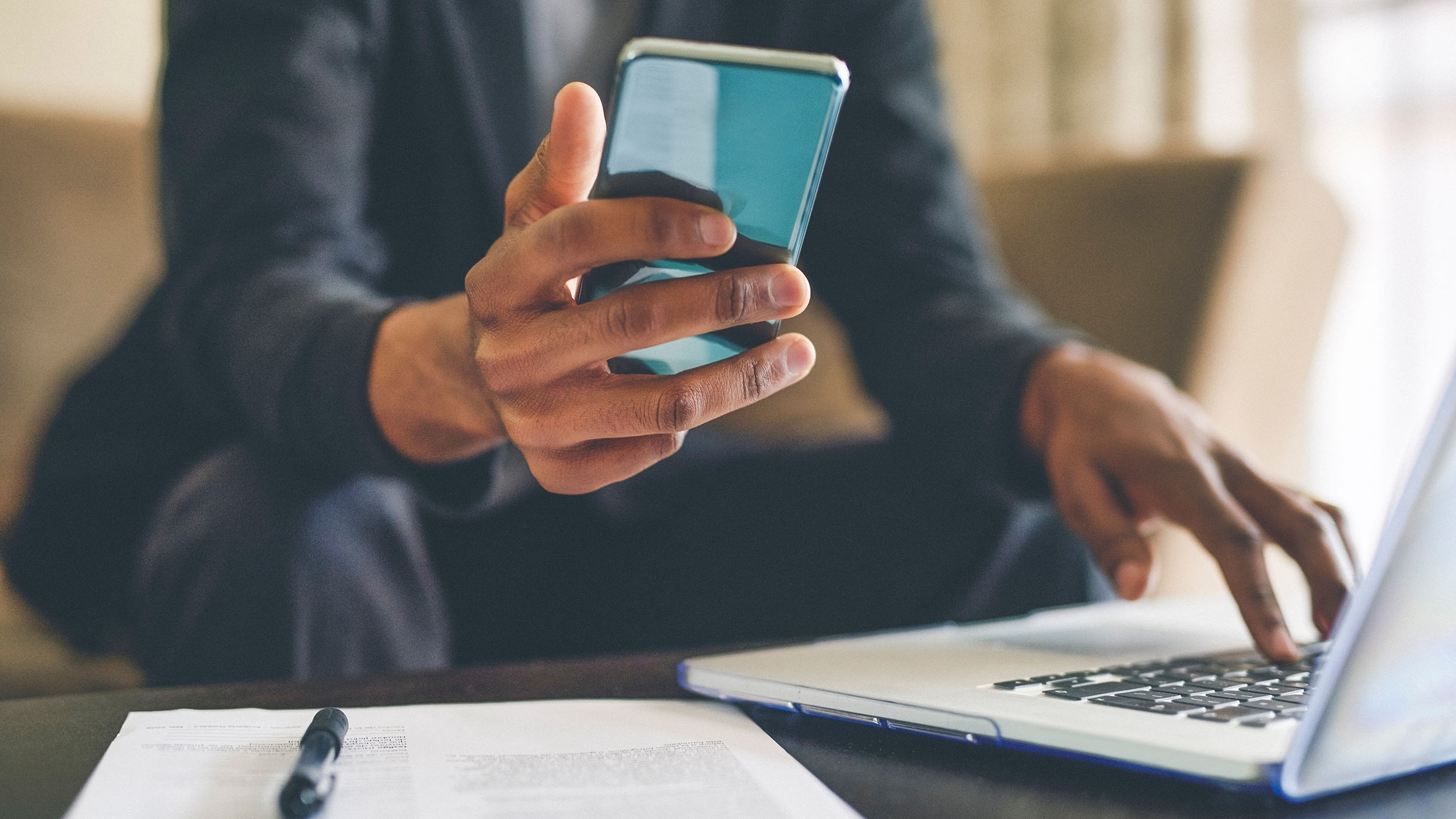 Person on computer and smartphone