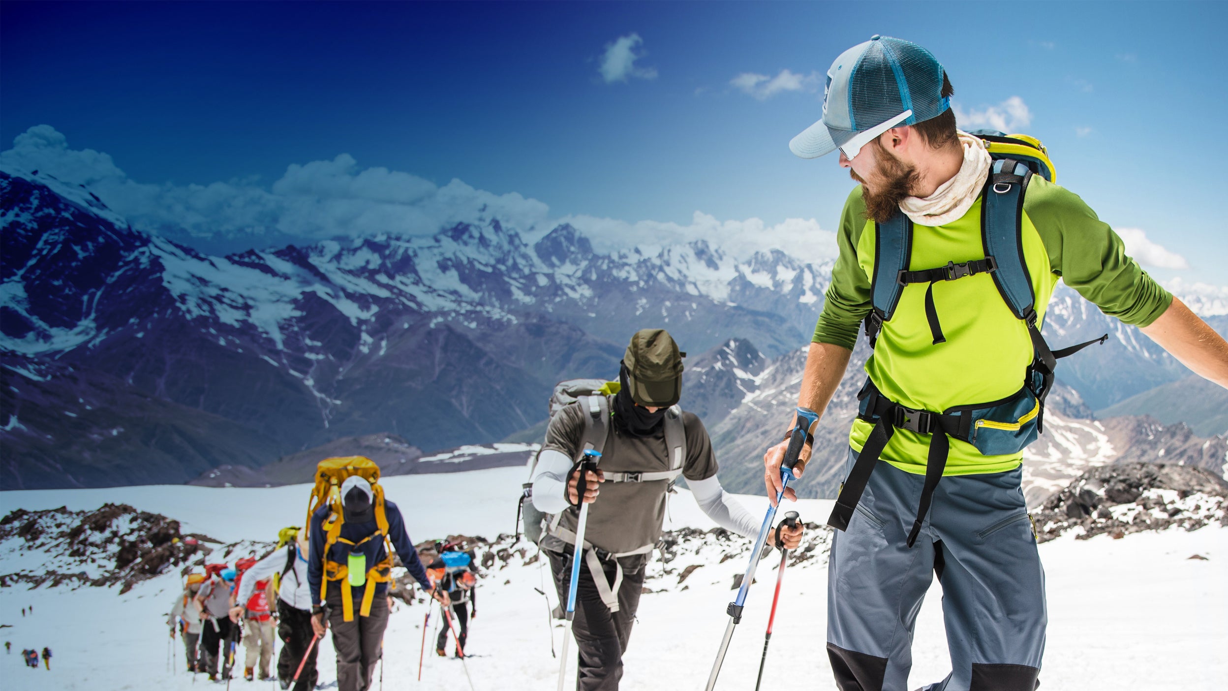 man guiding a team up a mountain 