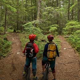 Two%20kids%20biking%20in%20the%20forest