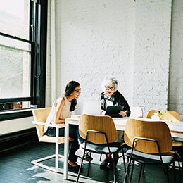 Older%20female%20financial%20advisor%20working%20with%20businessman%20at%20office