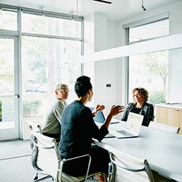 Three%20employees%20discussing%20in%20the%20office%20room.