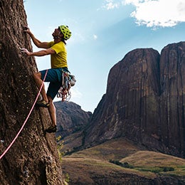 Man%20climbing%20a%20mountain%20with%20a%20grapple%20hook