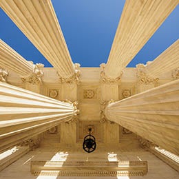 Upward%20view%20of%20marble%20columns%20against%20blue%20sky