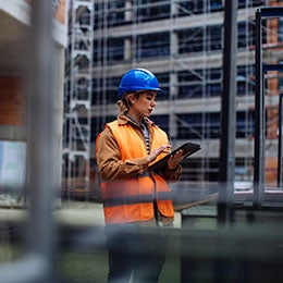 Young%20female%20worker%20using%20her%20digital%20tablet%20at%20a%20construction%20site