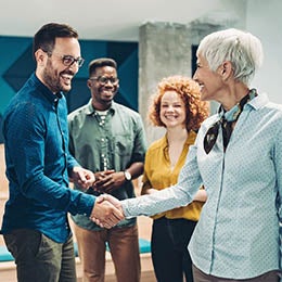 Smiling%20business%20persons%20shaking%20hands