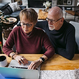 Senior%20couple%20looking%20at%20a%20laptop