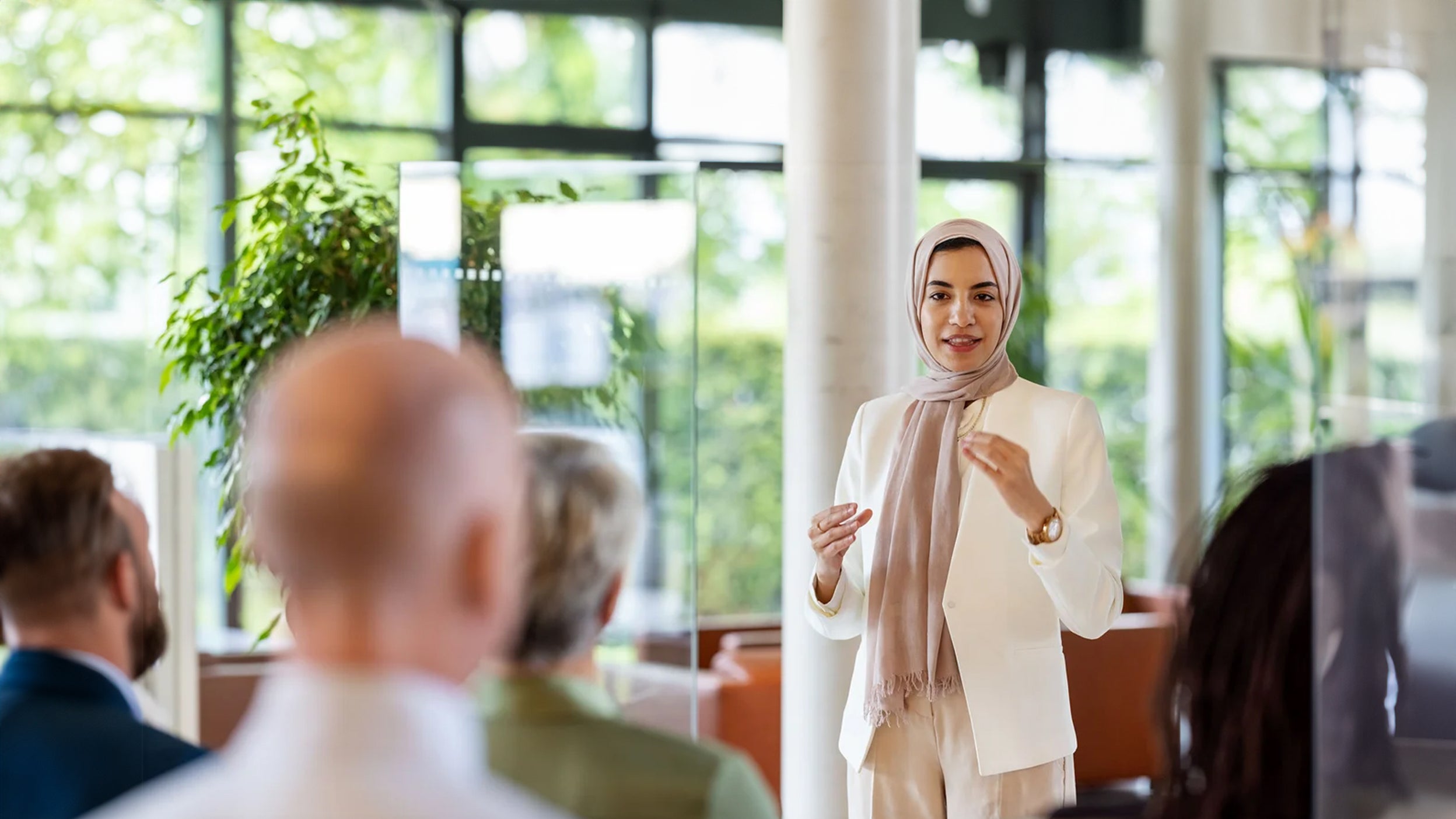 A woman is presenting in office