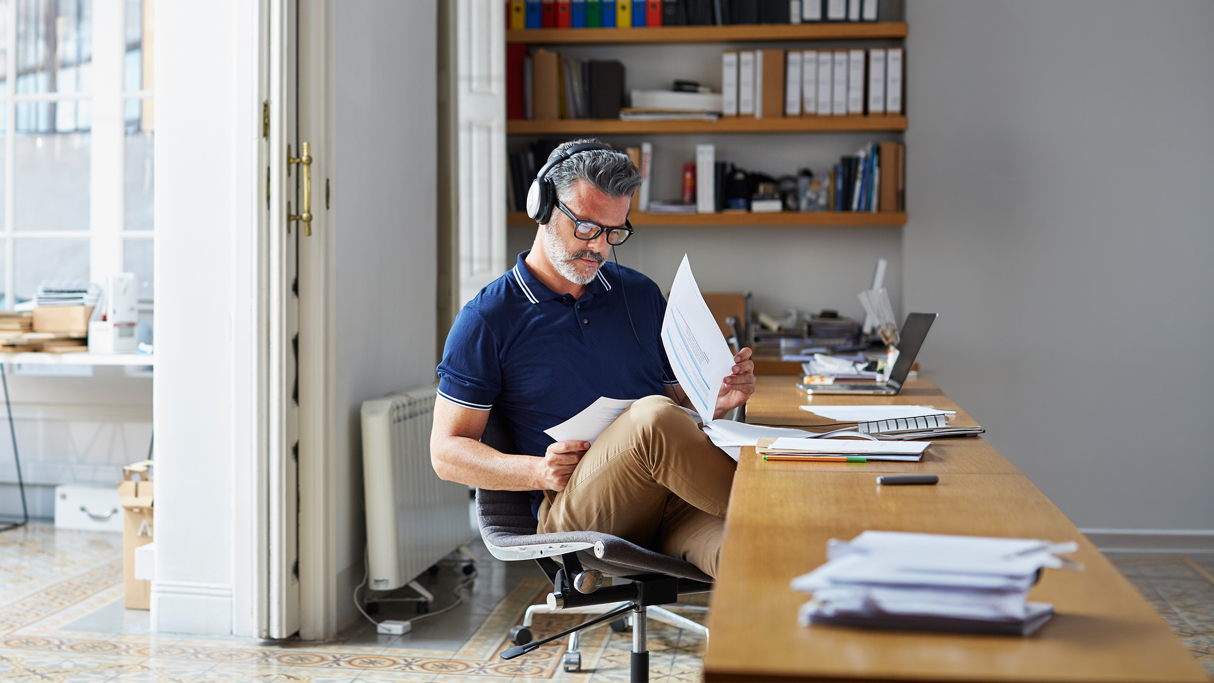 Person reviewing documents at a desk.
