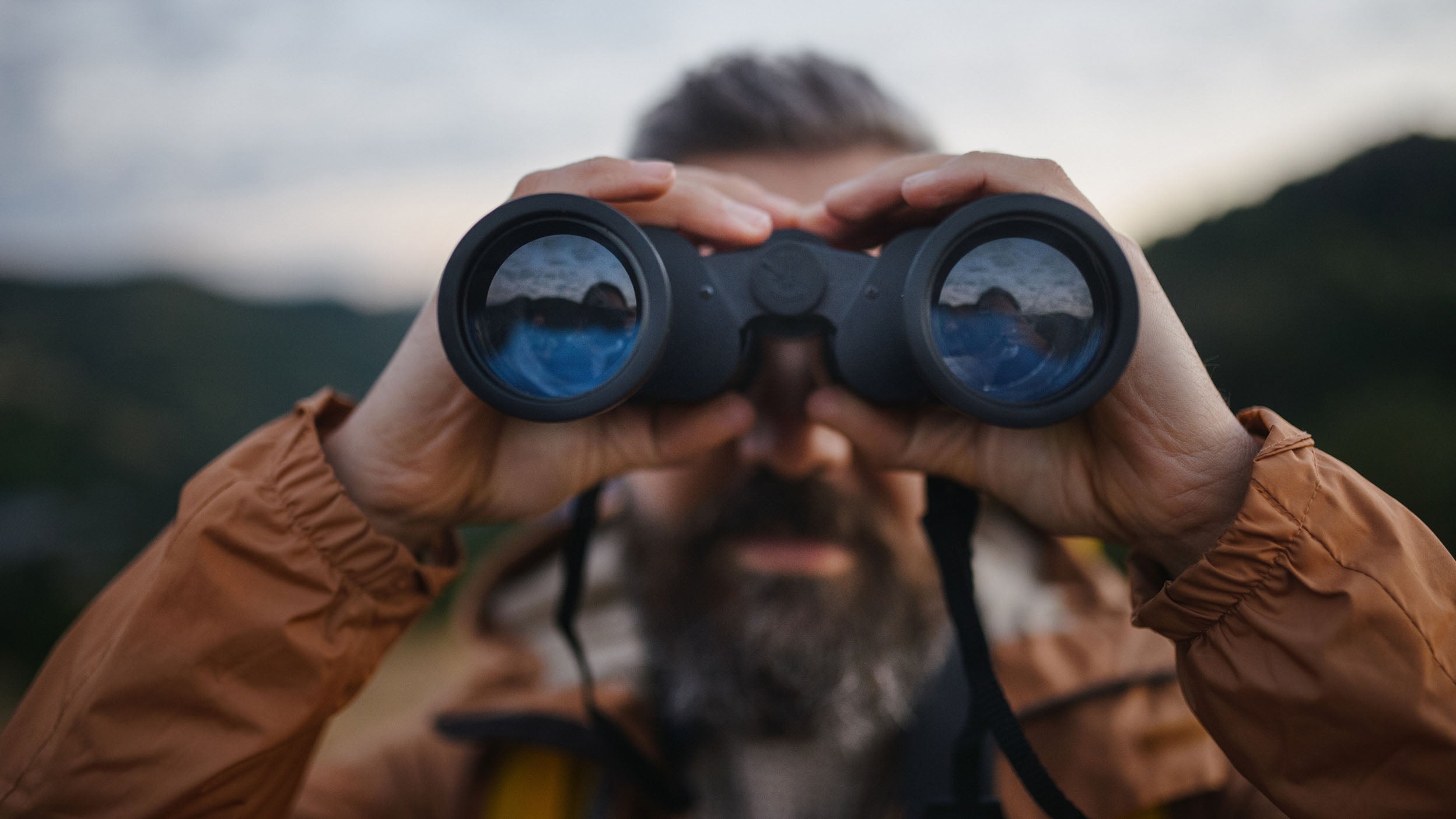 A person is looking through binocular