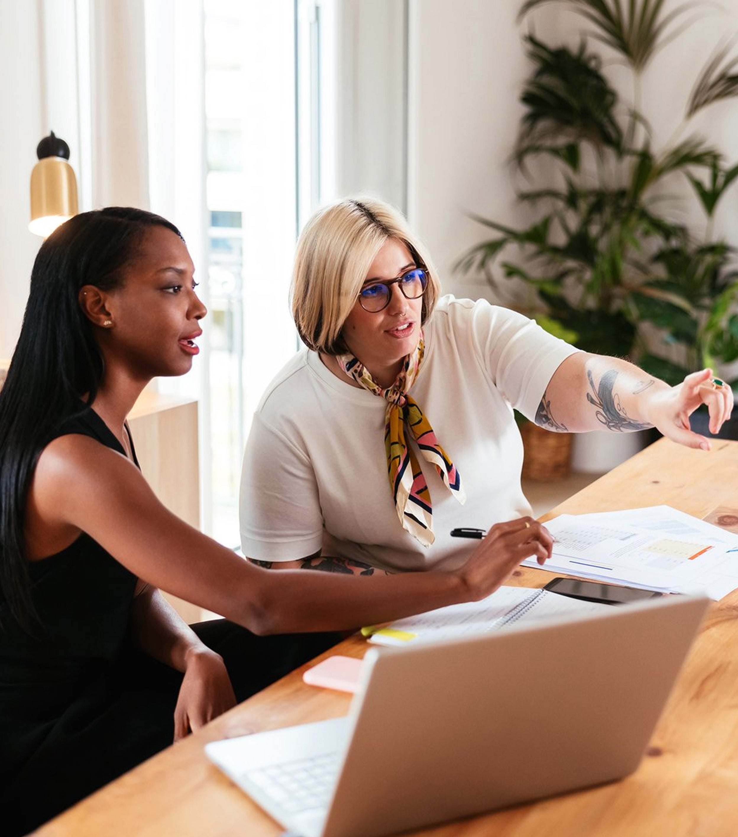 Two women reviewing information in a monitor