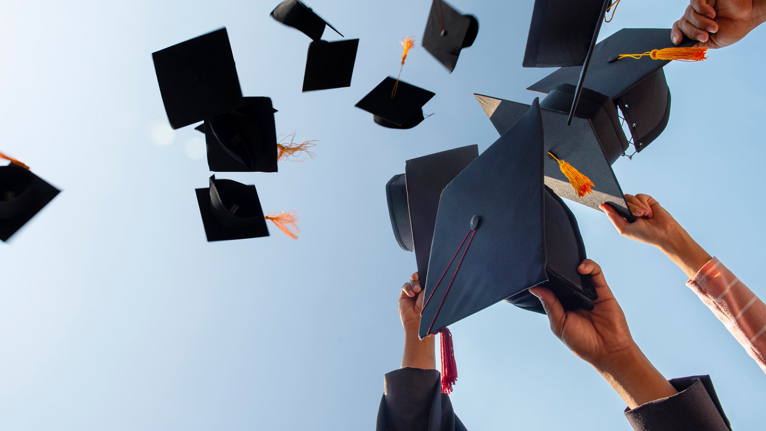 Graduation caps being thrown in celebration