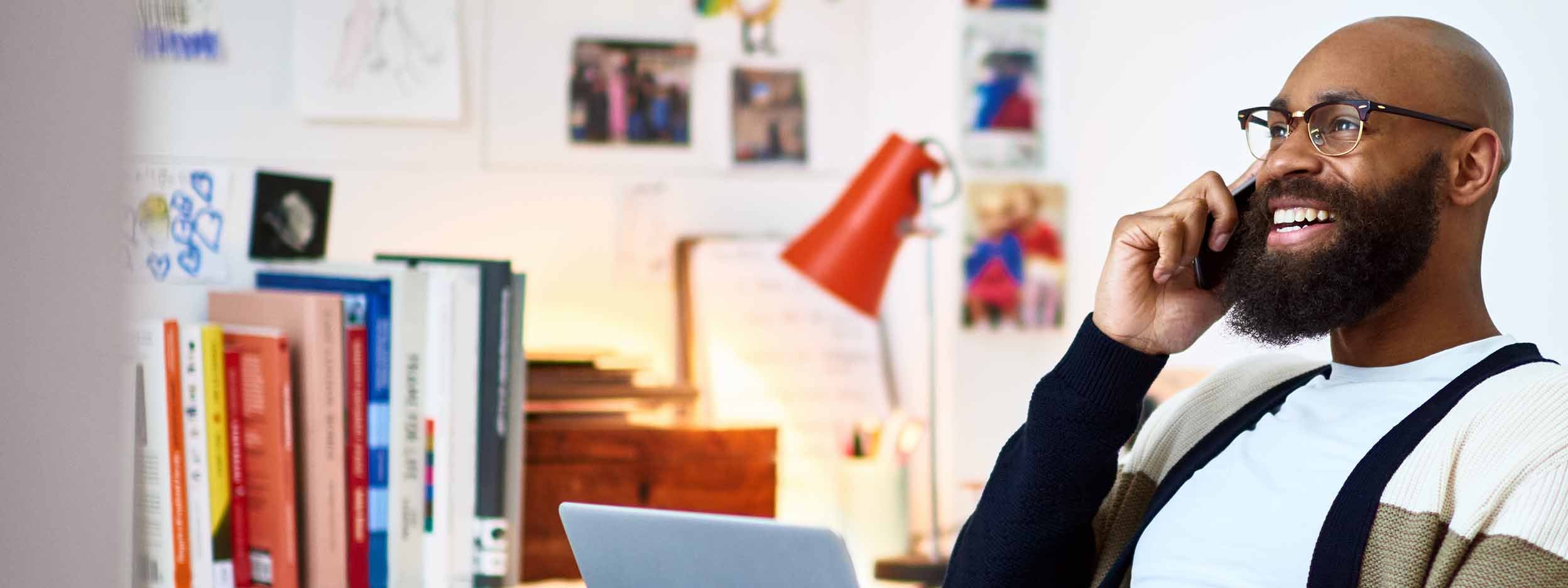 Man talking on the phone with laptop in-front