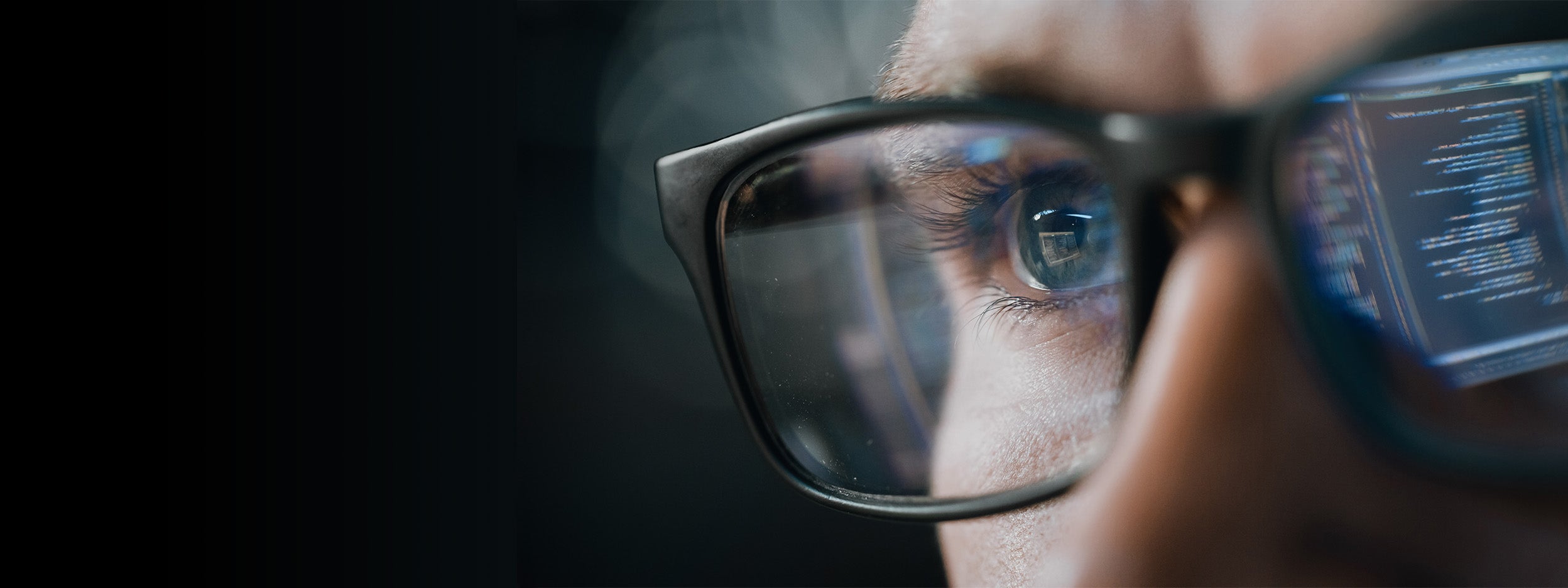 Market changes reflecting in a person's glasses