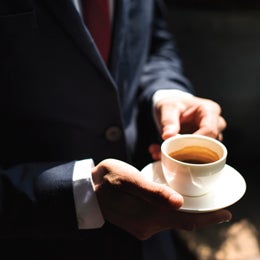 Person holding cup with coffee