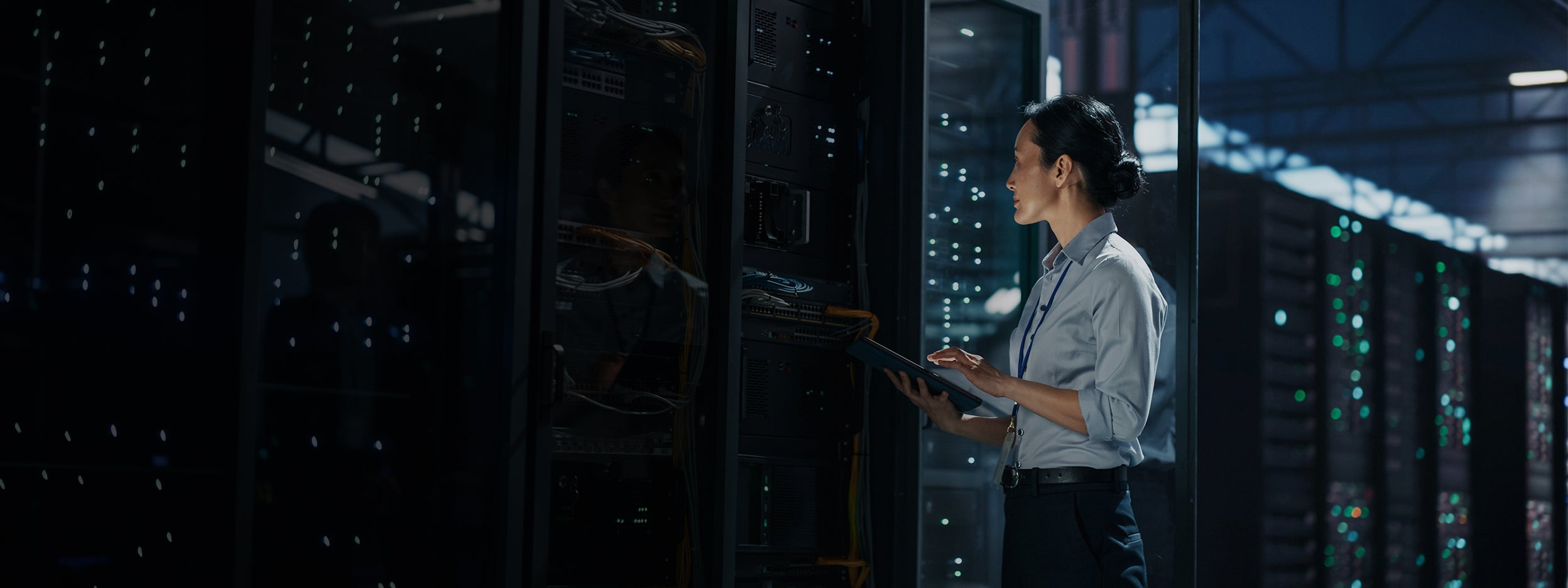 Person inspecting server racks in a data center